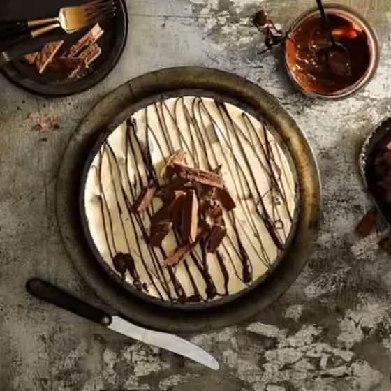 Finished Tim Tam cheesecake with chocolate drizzle and chopped Tim Tams on top